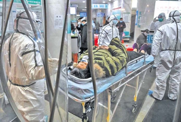 A Chinese COVID-19 patient being rushed into a Wuhan hospital