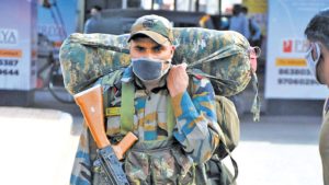 An Army soldier wearing a mask to prevent the spread of COVID-19 at Guwahati railway station