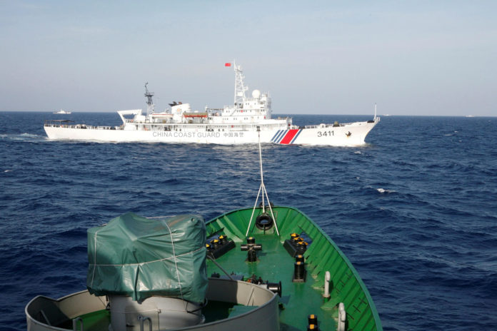 A Chinese Coast Guard ship is seen near a Vietnam Marine Guard ship in the South China Sea.