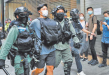 HONG KONG: China Adopts Decision on National Security Law Riot police officers detain a demonstrator during a protest against the second reading of a controversial national anthem law in Hong Kong, China May 27, 2020
