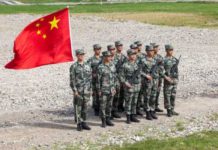 China threatens India with ‘severe’ military losses Chinese troops with flag