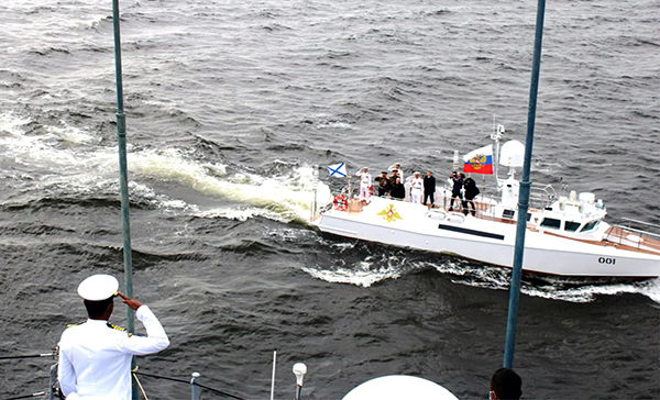 CO INS Tabar salutes as Vladimir Putin, President of Russia steams past in the presidential barge during the Navy Day parade on 25 July