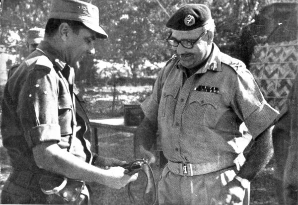 Maj Gen Kazi of Pakistan Army handing over his pistol as a mark of surrender