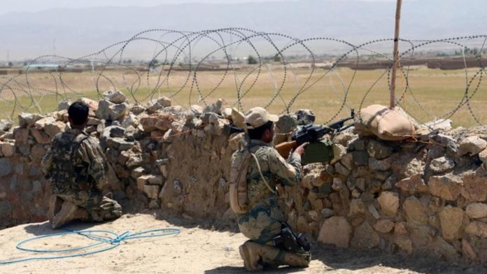 Afghan police personnel keep watch near the Durand Line