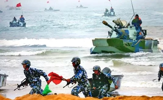 Developments in the South & East China Seas Chinese naval troops and amphibious armor advance ashore during an amphibious exercise.