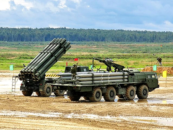 MLRS Smertch (9A52-2) in background and transporter-loader 9T234-2 with 12 rockets