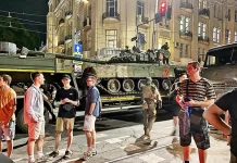 Prigozhin’s Revolt Against Putin Young people next to the tank PMCs Wagner
